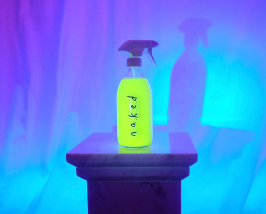 n.a.k.e.d 500ml glass spray bottle on bright background